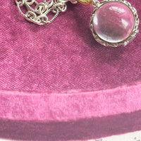Necklace styled flat, showcasing the pendant’s clear rock crystal
