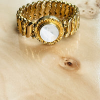 1940s gold filled sweetheart expansion bracelet with white Lucite center styled on burl wood