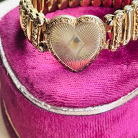1940s gold filled sweetheart bracelet with heart locket, shown with vintage jewelry box