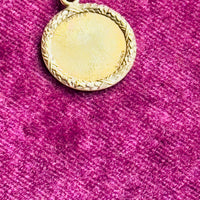 Flat lay of antique French love token necklace showing pendant size and chain styling