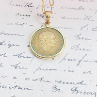 Close-up of Italian 200 Lire coin pendant in 14k gold bezel on paperclip chain