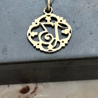 Antique French Lucky Number 13 charm pendant showcasing intricate openwork scrollwork in solid 18k gold.