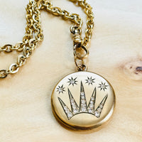 Antique celestial shooting star locket styled on an original watch chain, thoughtfully selected for modern wear.