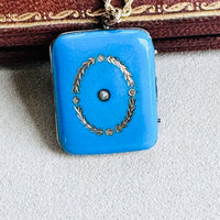 Close-up of blue enamel locket with seed pearl center
