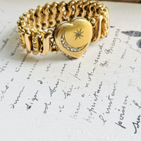 Carmen gold-filled sweetheart locket bracelet displayed on antique handwritten paper, showing its celestial moon and star design