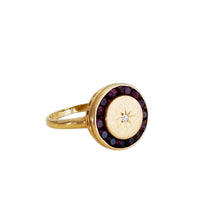 Close-up of Victorian garnet and diamond starburst ring in gold