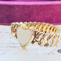Close-up of mother of pearl heart center on vintage Speidel bracelet