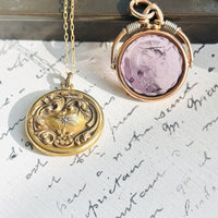 Close-up of original antique 14K gold diamond locket with repoussé detailing.