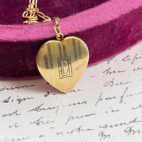 Close-up of vertical etched detailing on gold heart locket