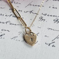 Close-up of English 12K gold heart padlock on mixed link 14K gold chain