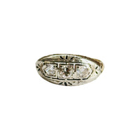 Edwardian three-stone diamond ring in two-tone 14K gold with filigree details