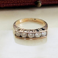 Estate 14K rose gold ring featuring five matched diamonds in graduated setting