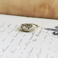 Estate three-stone diamond band in 14K gold with H color VS2 clarity stones