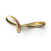 Full view of a vintage ruby snake bracelet in acid-tested gold with a flexible wrap design and sculpted serpent motif.