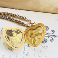 Interior of Victorian 10k gold heart locket open to show two image compartments with original photos intact, hipV Modern Vintage Jewelry