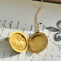 Interior of Victorian 14K gold locket open to hold two photographs.