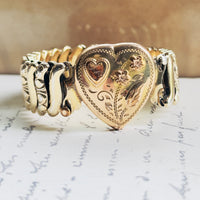 Jewel Guild mid-century sweetheart bracelet, gold filled over sterling silver base with milgrain heart face, pink enamel flowers, and LLD monogram