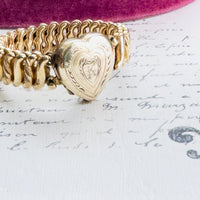 Side view of gold-tone expansion link design and locket craftsmanship.