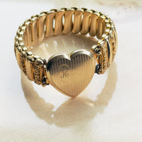 Layerable vintage gold statement bracelet with heart locket and engraved monogram, wide ornate expansion band, modern vintage jewelry