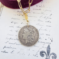 Morgan coin necklace styled flat with paperclip chain
