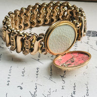 Original Carmen sweetheart bracelet with center locket opened to reveal space for two photographs or small mementos.