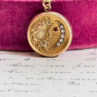 Antique celestial locket featuring a woman and crescent moon design