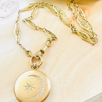 Victorian gold-filled crescent moon locket suspended from an antique French ORIA watch chain, full necklace view.