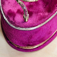 Vintage ruby snake bracelet displayed on a velvet antique ring box, highlighting the sculpted serpent head and natural ruby accents.