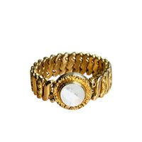 Front view of Gloria gold filled sweetheart bracelet with white Lucite medallion and scalloped expansion links on white