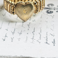 gold filled sweetheart bracelet with heart locket, shown with vintage jewelry box