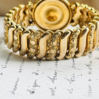 Reverse of vintage Gloria sweetheart bracelet showing the back of the round center and gold filled expansion links