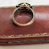 ruby and diamond ring in 14K yellow gold with rope twist band detail