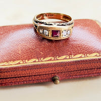 ruby ring with crown motif and rope twist shoulders