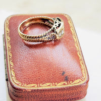 ruby ring with rope twist detail and prong-set diamonds