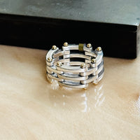 Tiffany & Co. two-tone Gate Link ring on marble beside a dark box