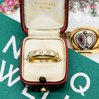 Antique gold ring with trilogy design featuring 3 diamonds.