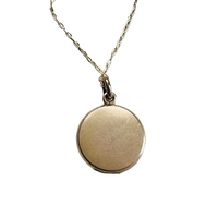 Art Deco jewelry featuring antique locket that opens to hold two photos.