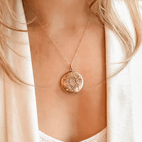 Keepsake locket, vintage antique necklace is gold filled and opens to hold two photos.