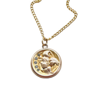 Antique gold filled locket featuring a side profile cameo of a lady accented with 5 paste stone. This keepsake locket opens to hold 2 photos of your choosing