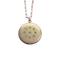 Close-up of antique gold-filled sunburst paste locket on paperclip chain