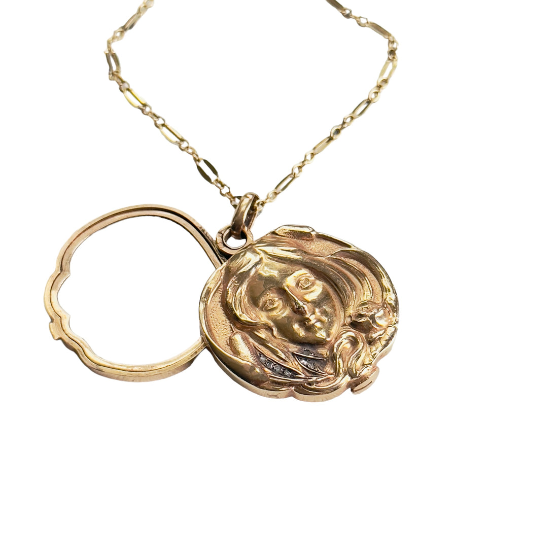 Antique Art Nouveau photo locket in 18k gold, showcasing a raised female portrait and diamonds"
