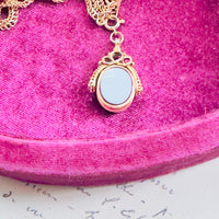 Blue agate fob hanging from clasp, highlighting swivel connection.