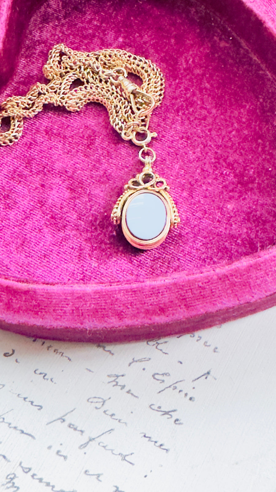 Blue agate fob hanging from clasp, highlighting swivel connection.