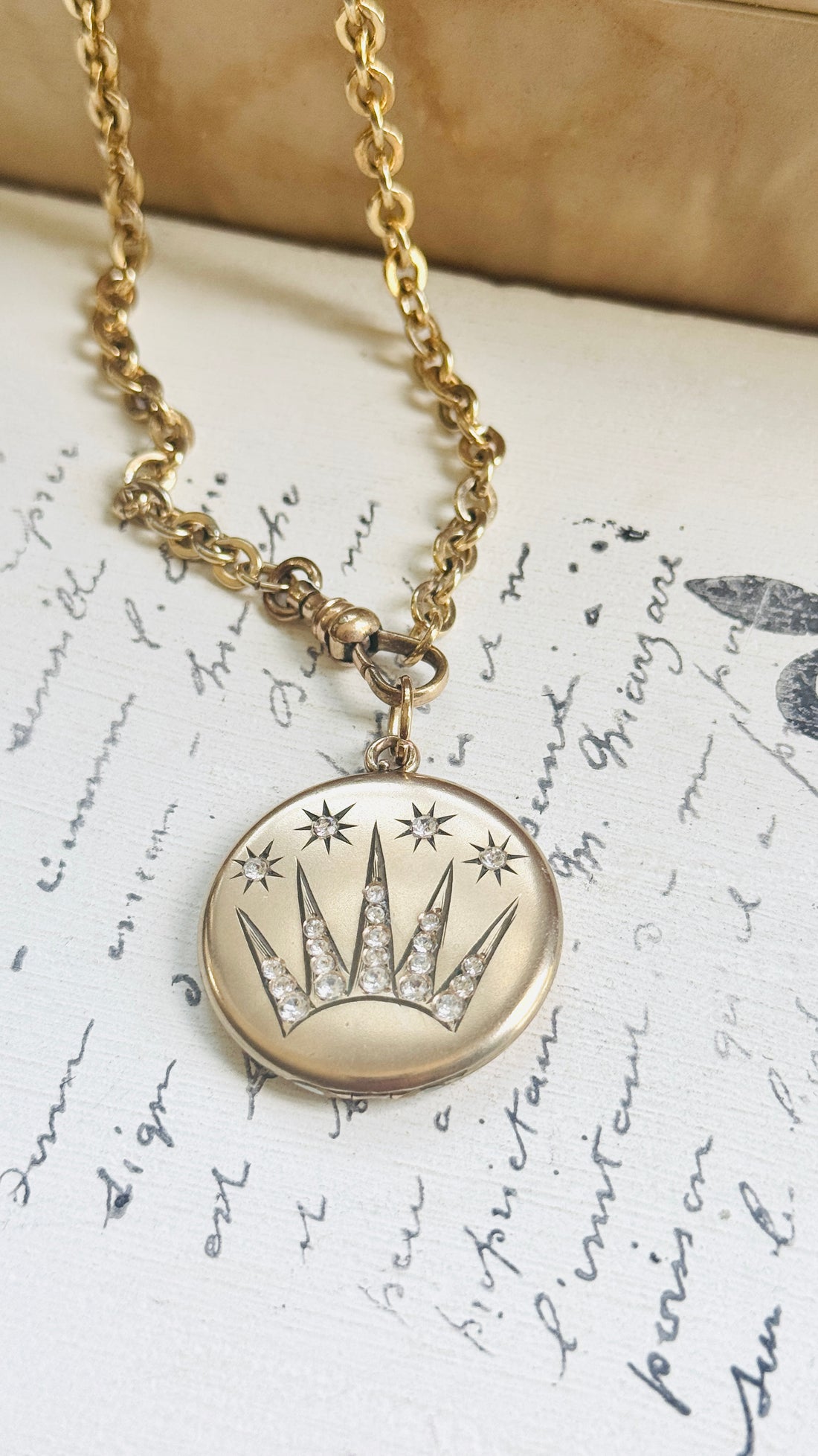 Antique Edwardian celestial locket necklace displaying a shooting star motif with sparkling original paste stones.