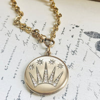 Antique Edwardian celestial locket necklace displaying a shooting star motif with sparkling original paste stones.