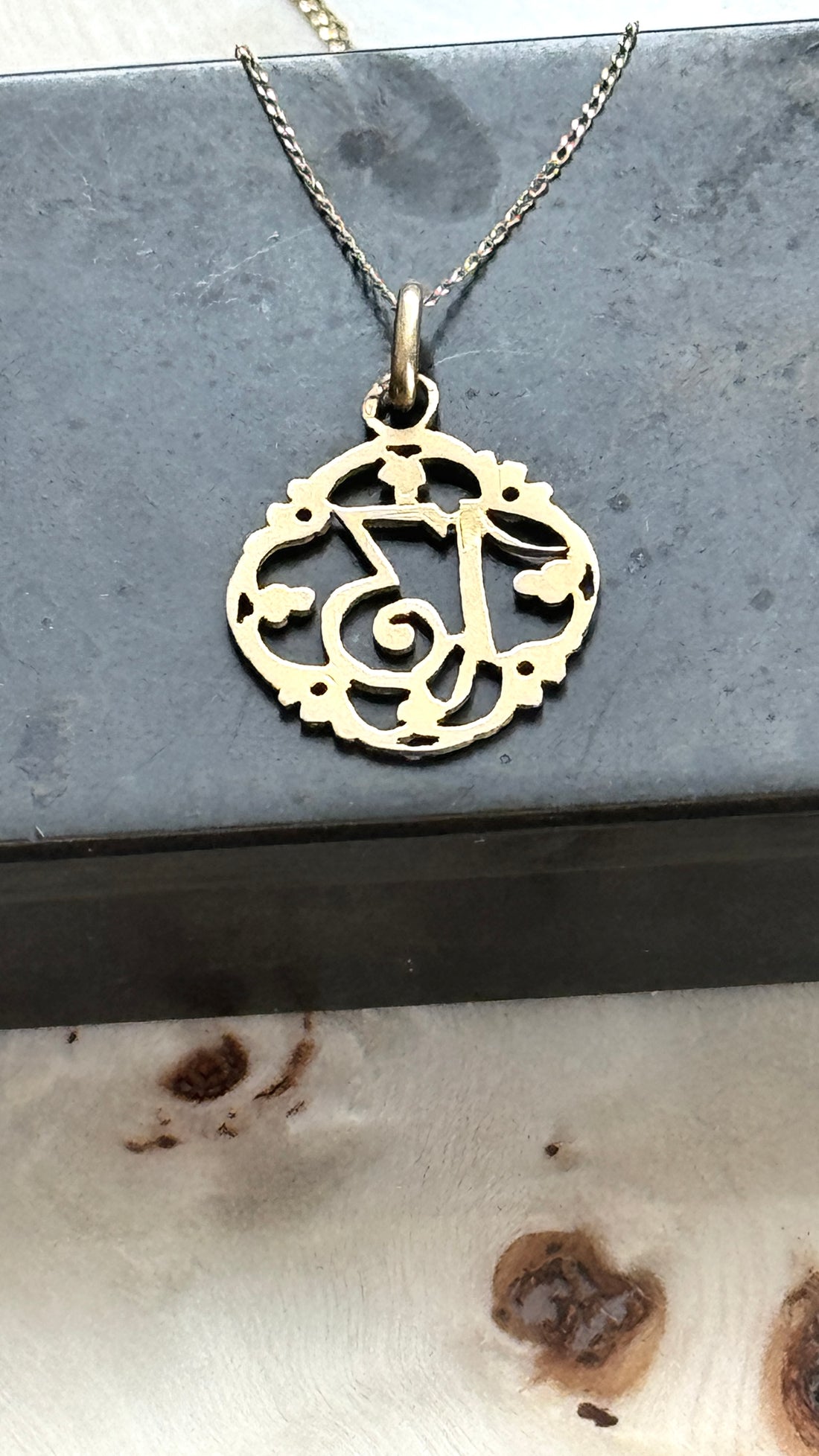 Antique French Lucky Number 13 charm pendant showcasing intricate openwork scrollwork in solid 18k gold.