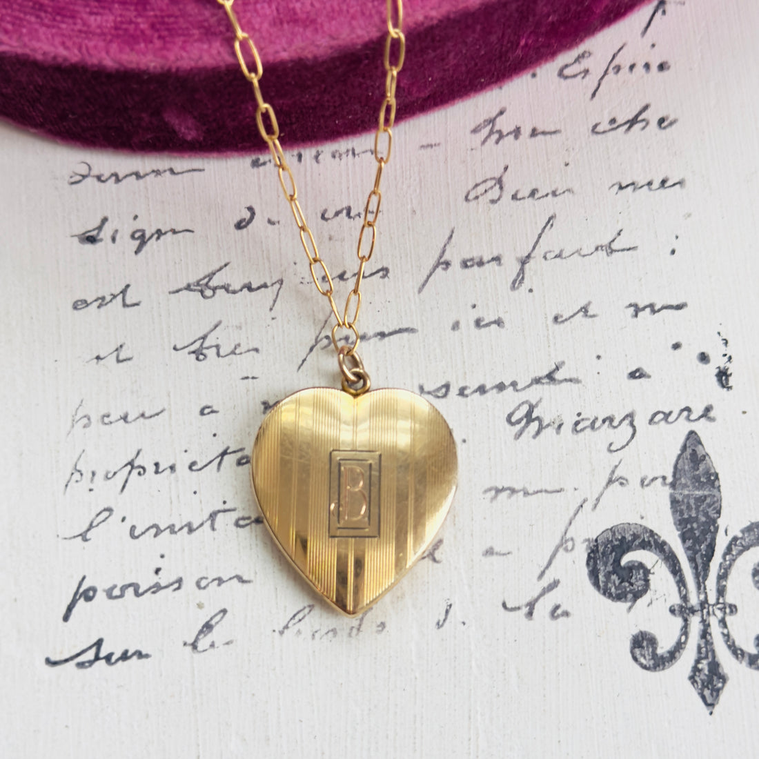 Locket displayed on 18-inch gold-filled paperclip chain