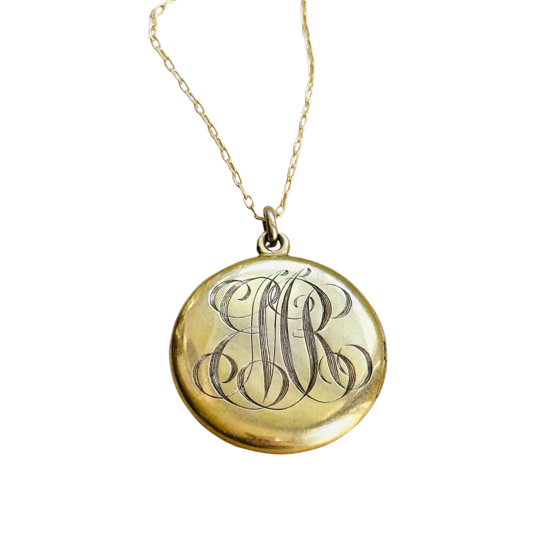 Antique Victorian gold locket showing original engraved monogram on reverse.