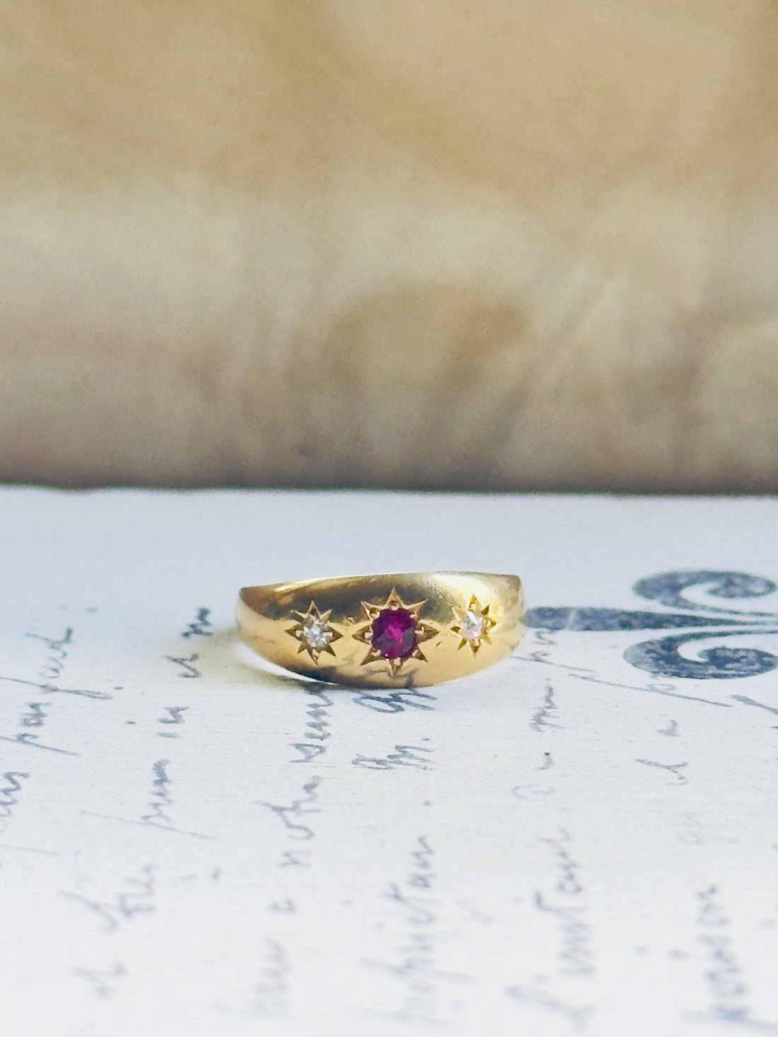 Antique Victorian ruby and diamond three-stone ring in 18k yellow gold, flush gypsy setting, hand-engraved star detail, hipV Vintage
