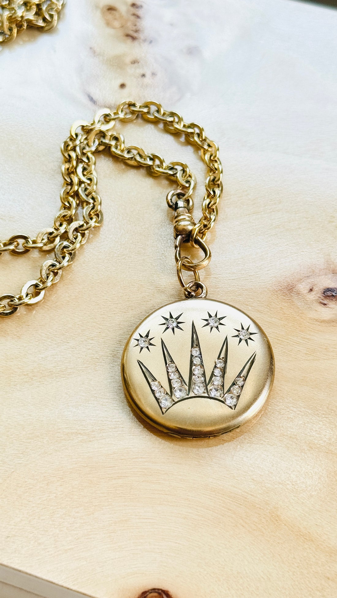 Antique celestial shooting star locket styled on an original watch chain, thoughtfully selected for modern wear.